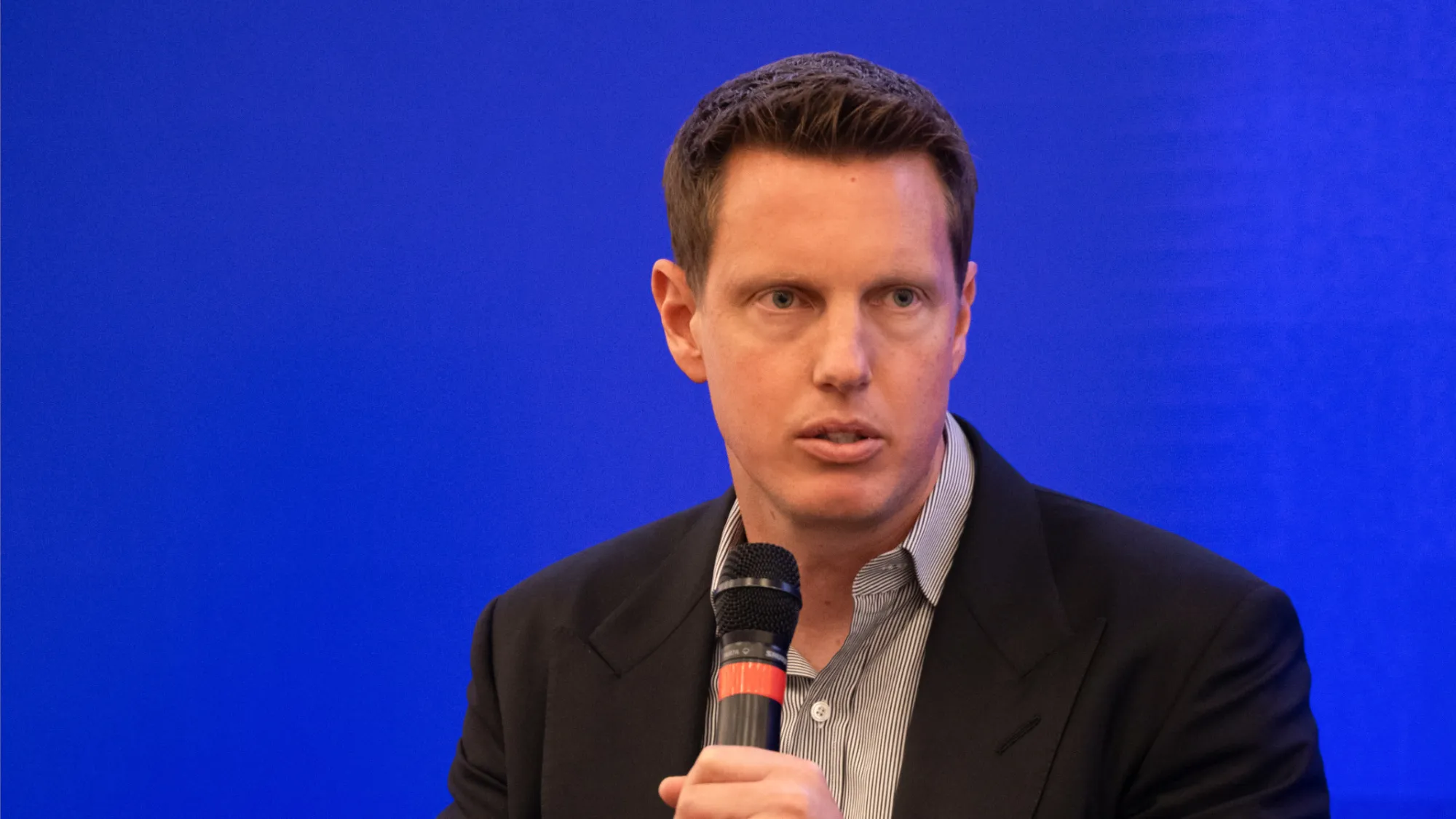 David Ellison attending an entertainment industry event, wearing a suit