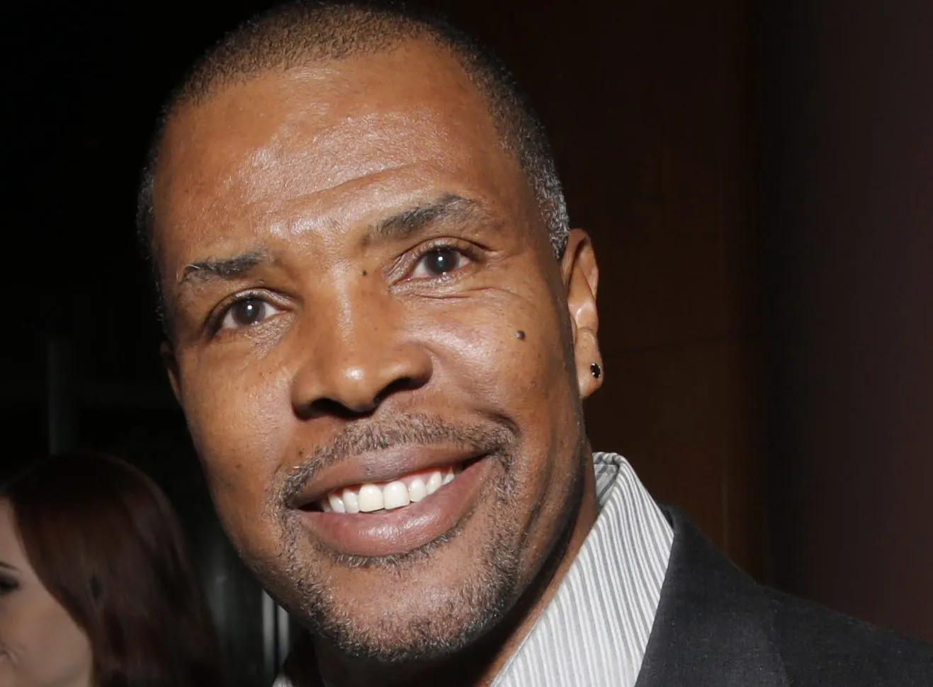 Eriq La Salle attending a 1990s red carpet event, wearing a suit and looking toward the press line.