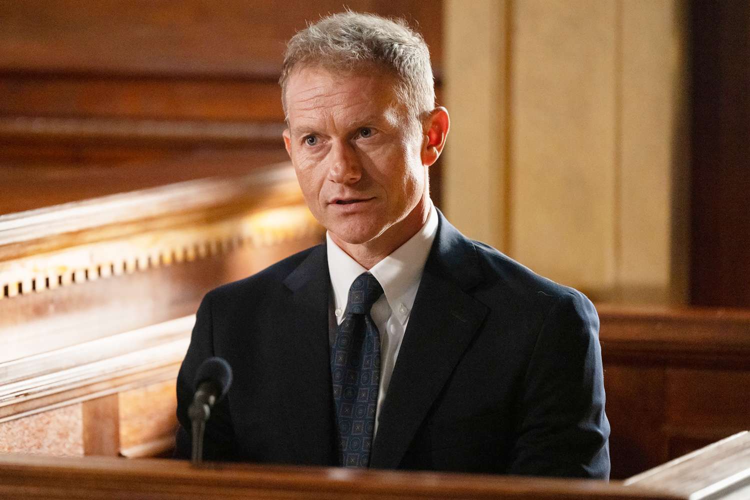 James Badge Dale on the set of Law & Order, standing under production lighting during a scene setup.