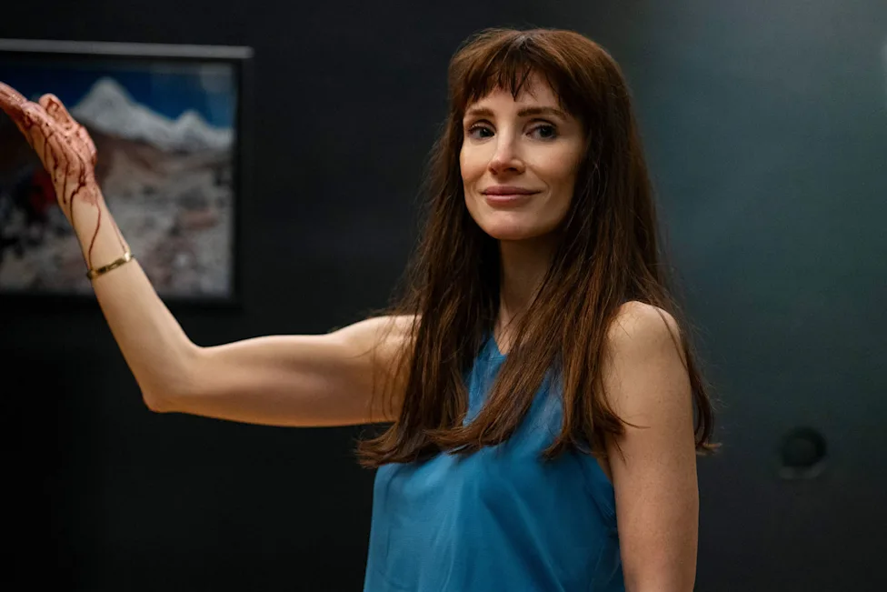 Jessica Chastain in a tense, dimly lit interior, her expression split between warmth and menace, cinematic horror still