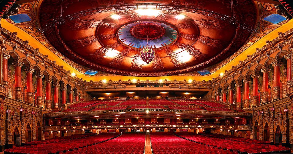 The ornate interior of Atlanta’s Fox Theatre with its dramatic ceiling details and glowing stage lights before a performance